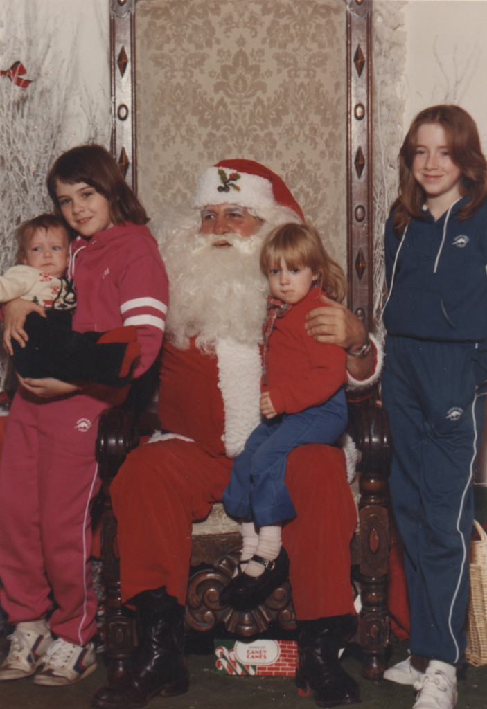 My lovely sisters (and me, the cute blonde one). You gotta love an awkward Santa picture. And sisters in matching tracksuits.